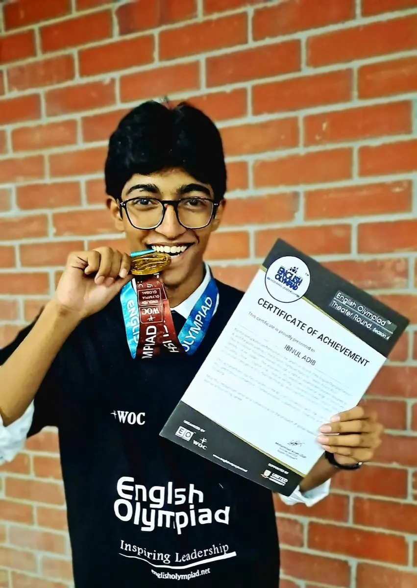 Ibnul Adib celebrating his Medal for Excellence with certificate of achievement