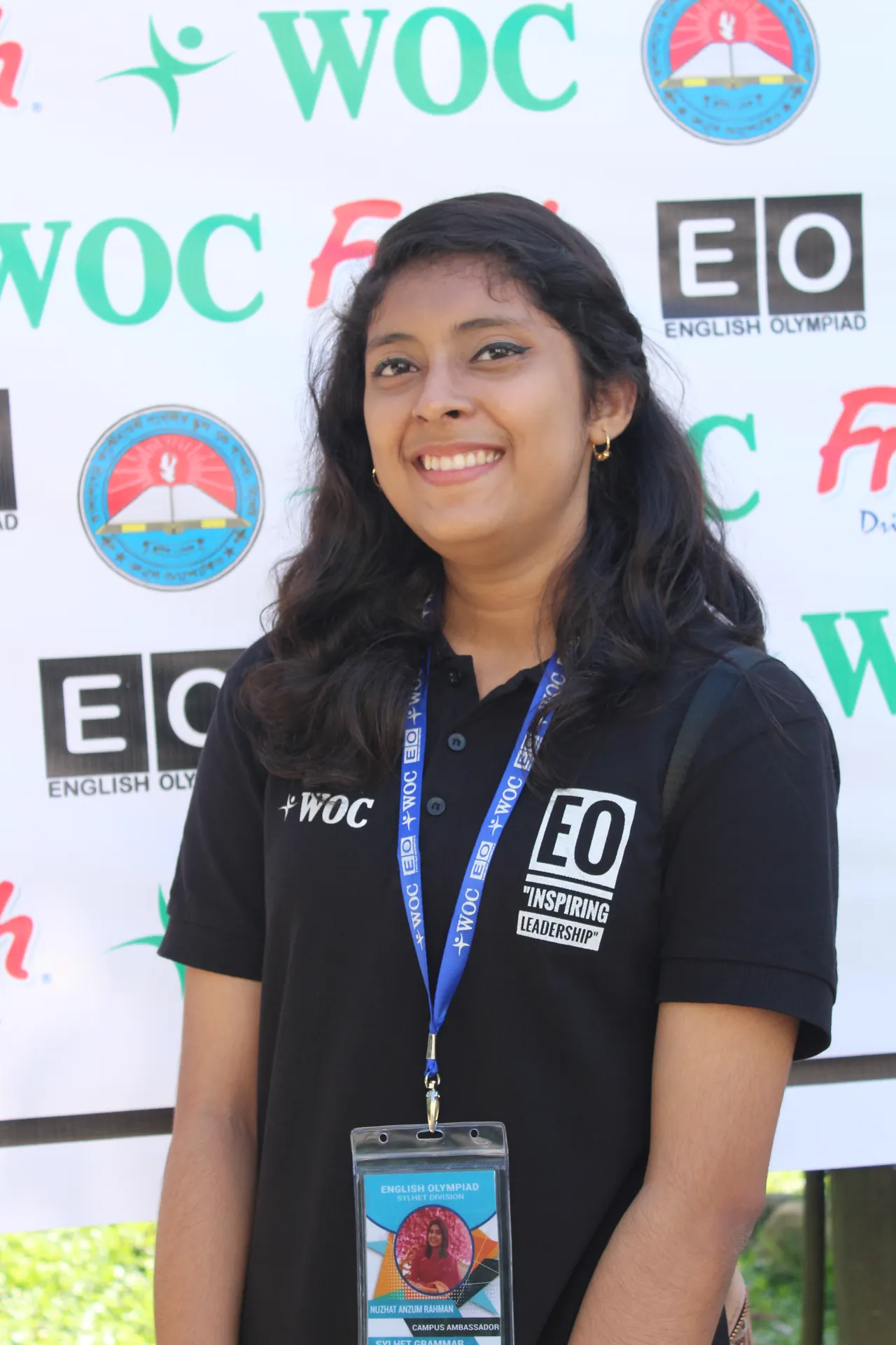 Campus Ambassador smiling with EO lanyard and badge